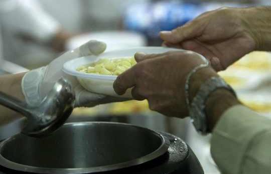 Free meals are served in a "soup kitchen" run by the Sant'Egidio Christian community in Rome.