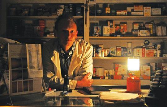 A pharmacist in Ħamrun went back to basics and served his clients with a lantern in hand after the whole island was hit by a blackout yesterday. Photo: Chris Sant Fournier.