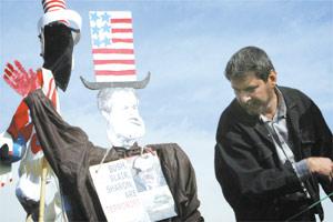 An Iranian looks at an effigy of US President George W. Bush during celebrations to commemorate the 25th anniversary of Iran`s Islamic revolution at Tehran`s Azadi (Freedom) Square on Wednesday.