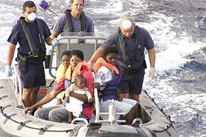 Illegal immigrants, including a nine-month old boy, being transferred from the Norfolk Express to the AFM patrol boat.